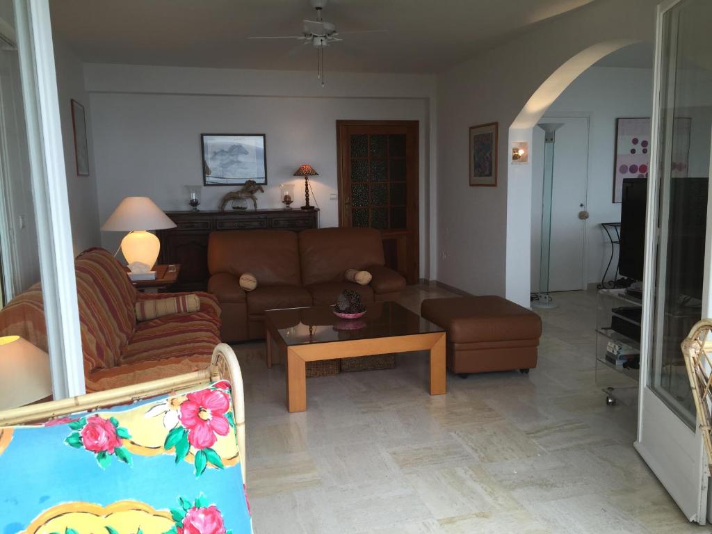 a living room with a couch and a table at Villa Bellochio in Menton