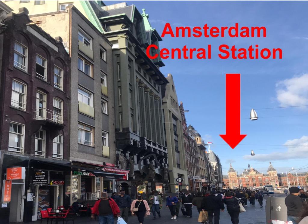 a group of people walking down a city street at Orange Tulip Hotel in Amsterdam