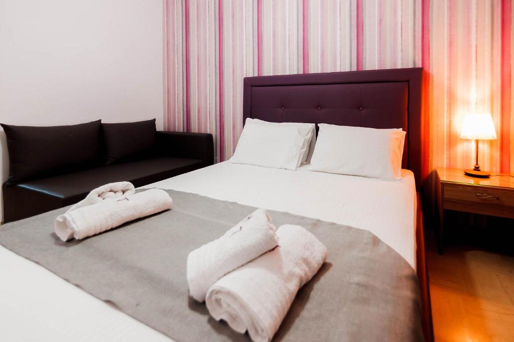 Postel nebo postele na pokoji v ubytování Hotel Torini