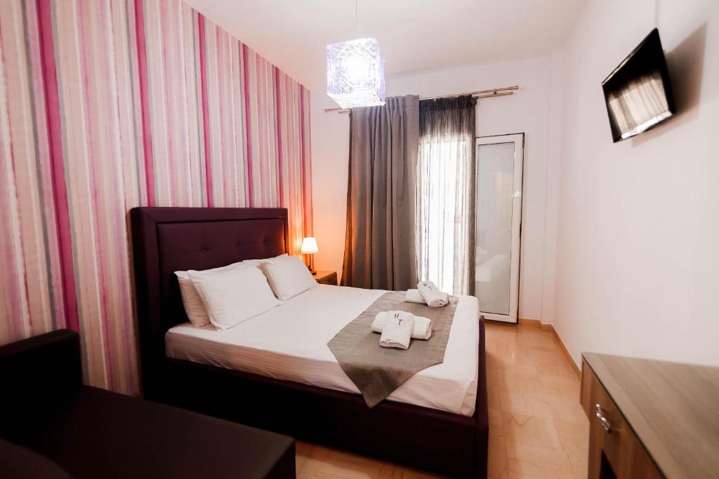 Postel nebo postele na pokoji v ubytování Hotel Torini