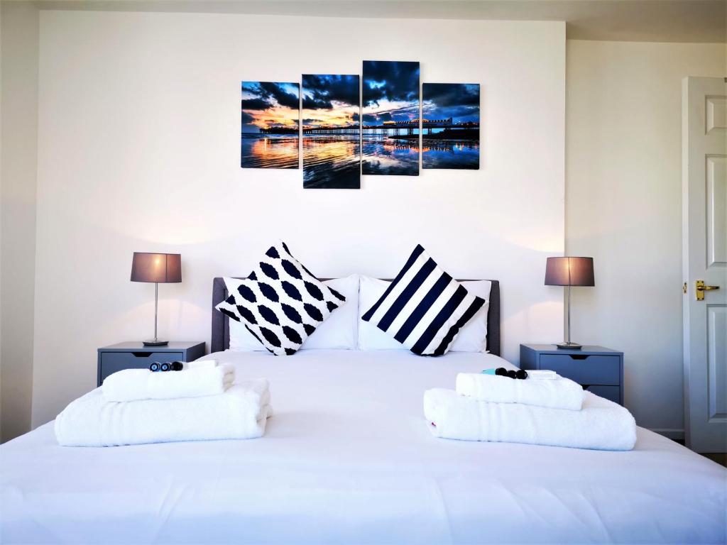 a bedroom with a white bed with two pillows at Marina living with parking, balcony, quiet and secure in Brighton & Hove