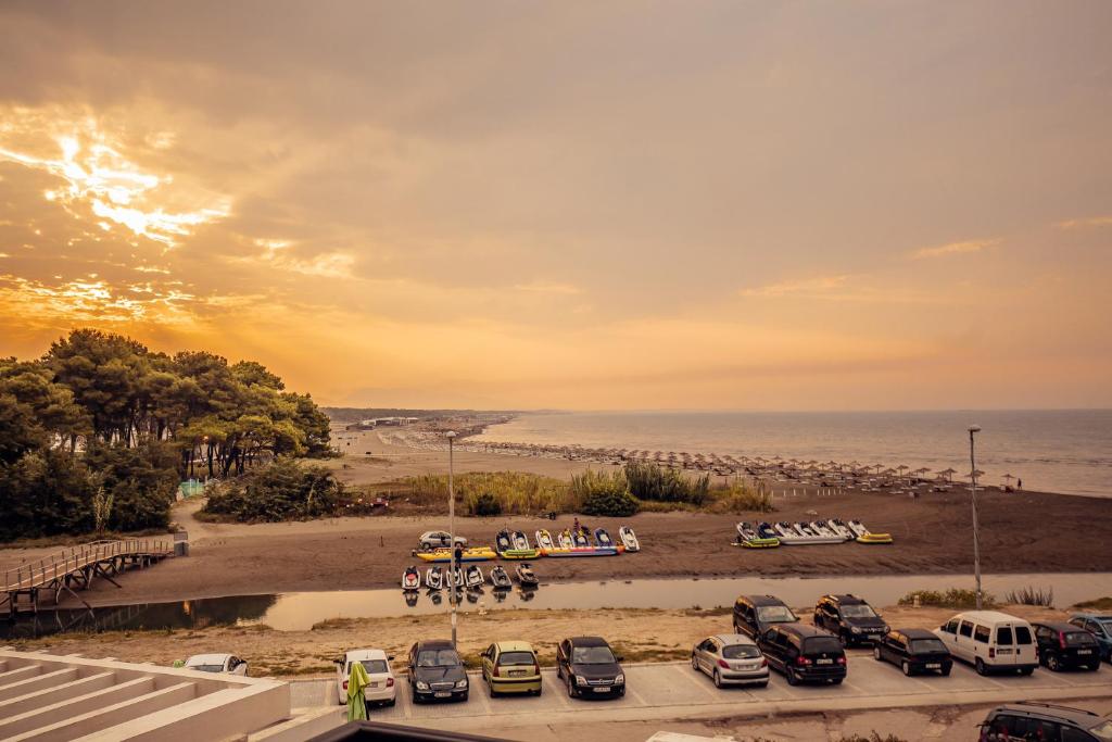 a parking lot with cars parked on the beach at Adriatic Apartment in Ulcinj