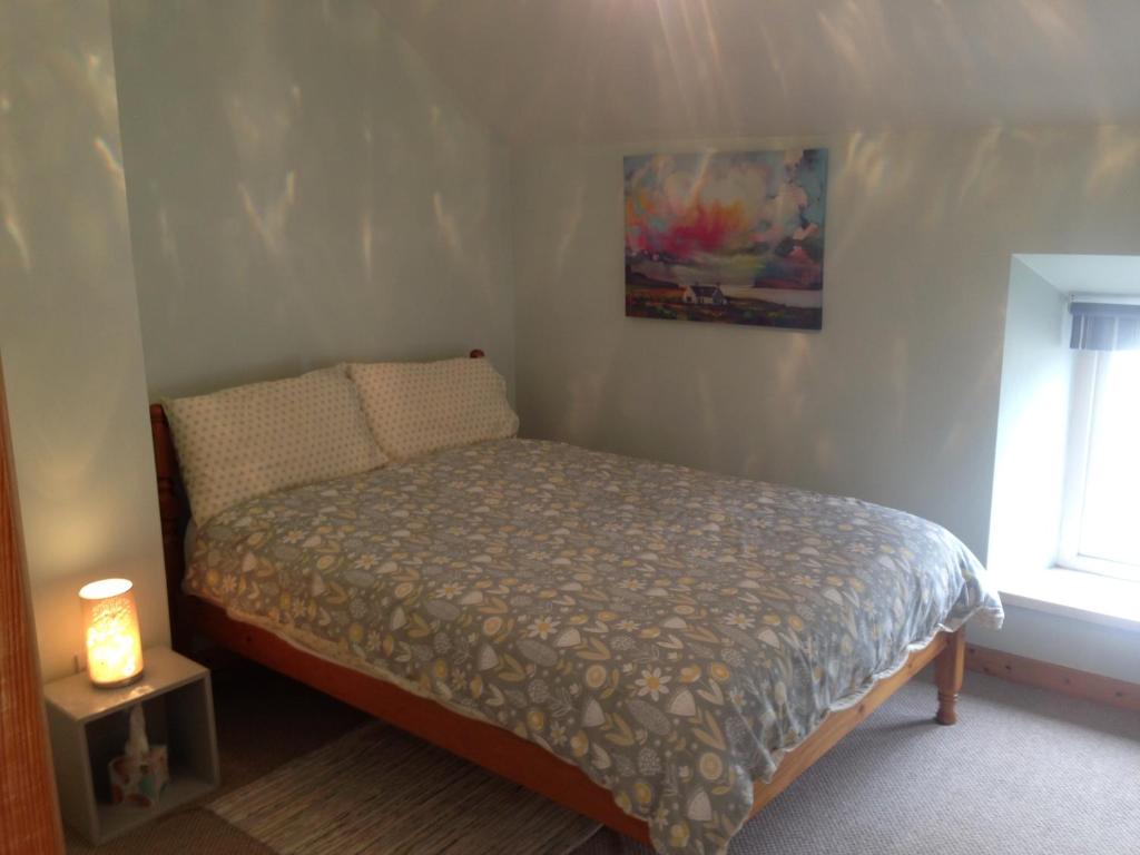 a small bed in a bedroom with a window at Glaslough Ramblers Rest in Monaghan