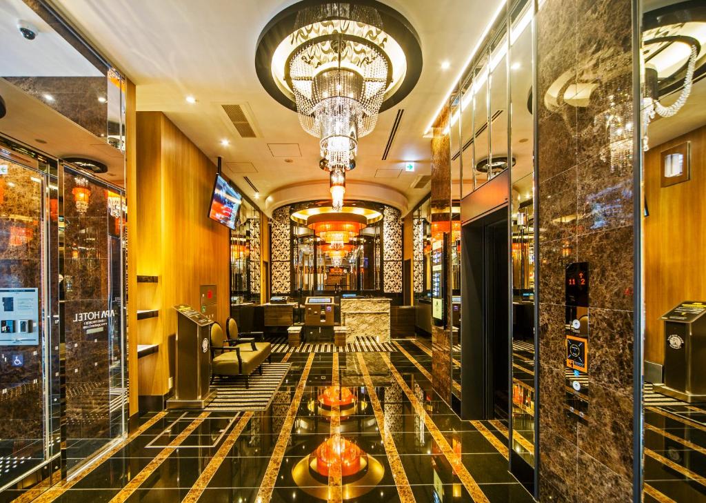 a lobby of a hotel with a chandelier at APA Hotel Ueno Hirokoji in Tokyo