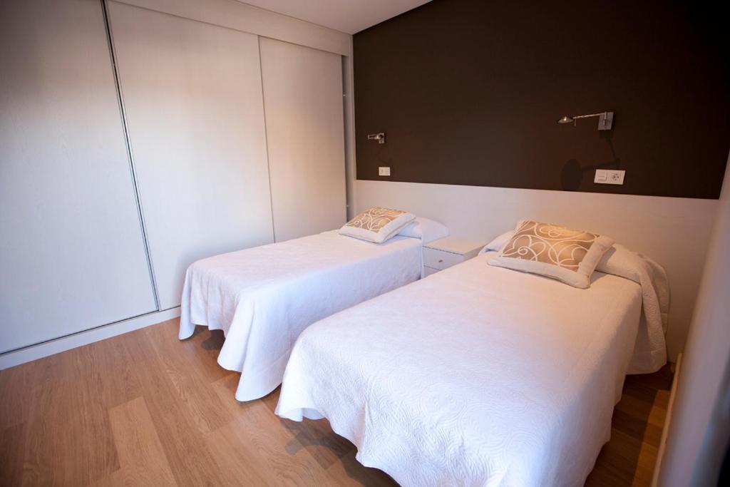 Postel nebo postele na pokoji v ubytování Costa Quebrada Apartamentos