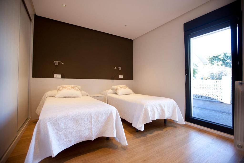 Postel nebo postele na pokoji v ubytování Costa Quebrada Apartamentos