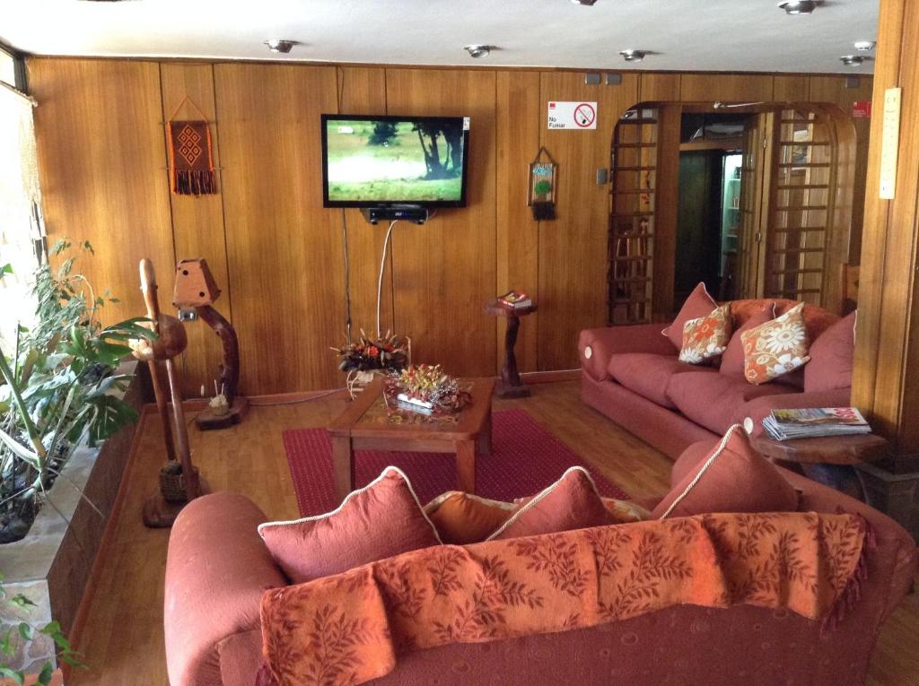 TV a/nebo společenská místnost v ubytování Hotel Le Mirage
