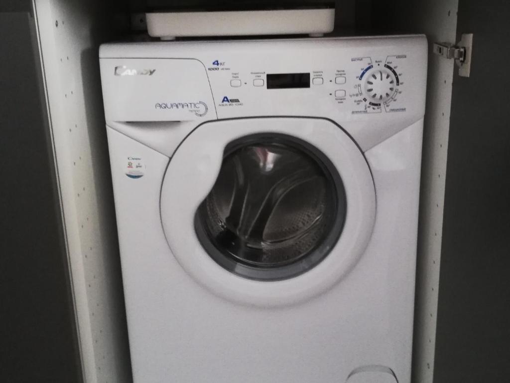 a white washing machine sitting in a room at Apartment HOLIDAY HOUSE in Sukko