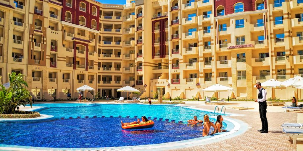 a group of people in a pool at a hotel at Apartments in Florenza Khamsin in Hurghada