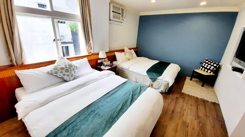 Postel nebo postele na pokoji v ubytování Kenting Chingshan Inn