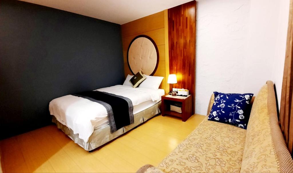 Postel nebo postele na pokoji v ubytování Kenting Chingshan Inn