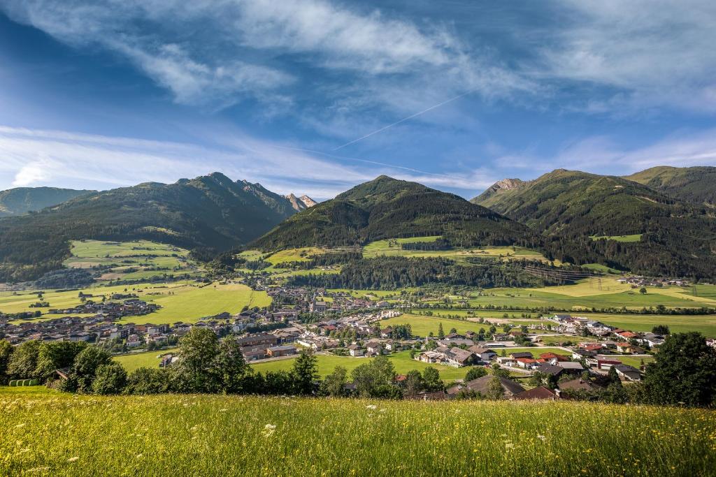 a town in a valley with mountains in the background at Alpine View Apartments in Niedernsill