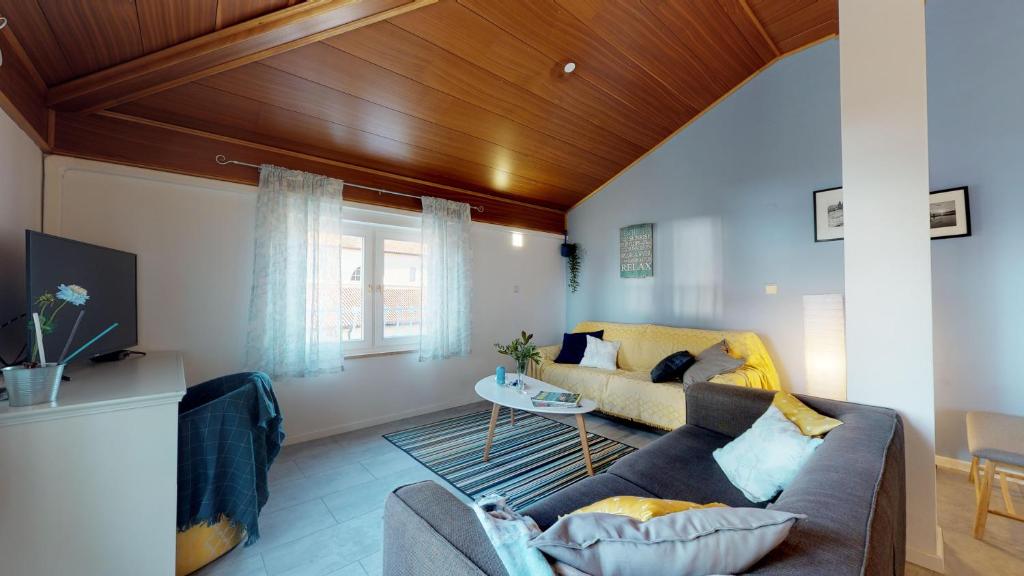 a living room with a couch and a table at LORA apartment with beautiful sea & park view in Novigrad Istria