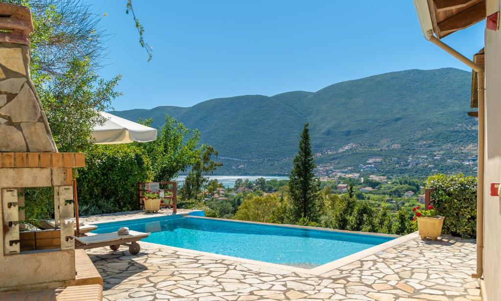 a swimming pool with a view of a mountain at Kerithra Villa in Vasiliki