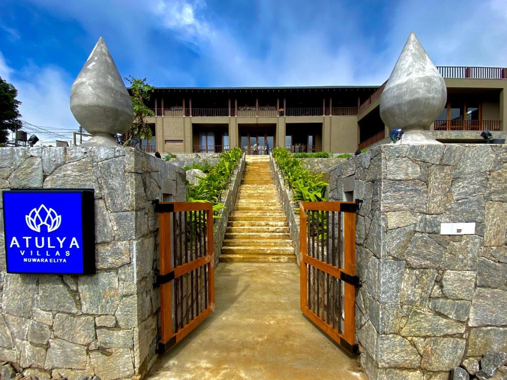 a gate at the entrance to a building with stairs at Atulya Villas Nuwara Eliya in Nuwara Eliya