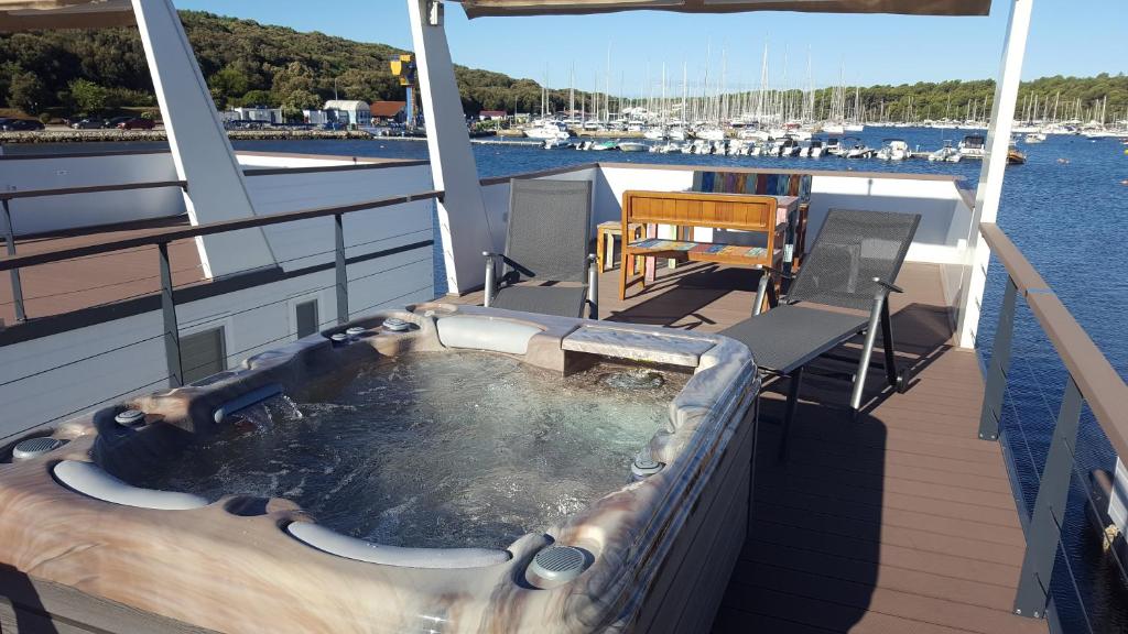 a hot tub on the deck of a boat at House boat - Floating House Water Lily in Pula