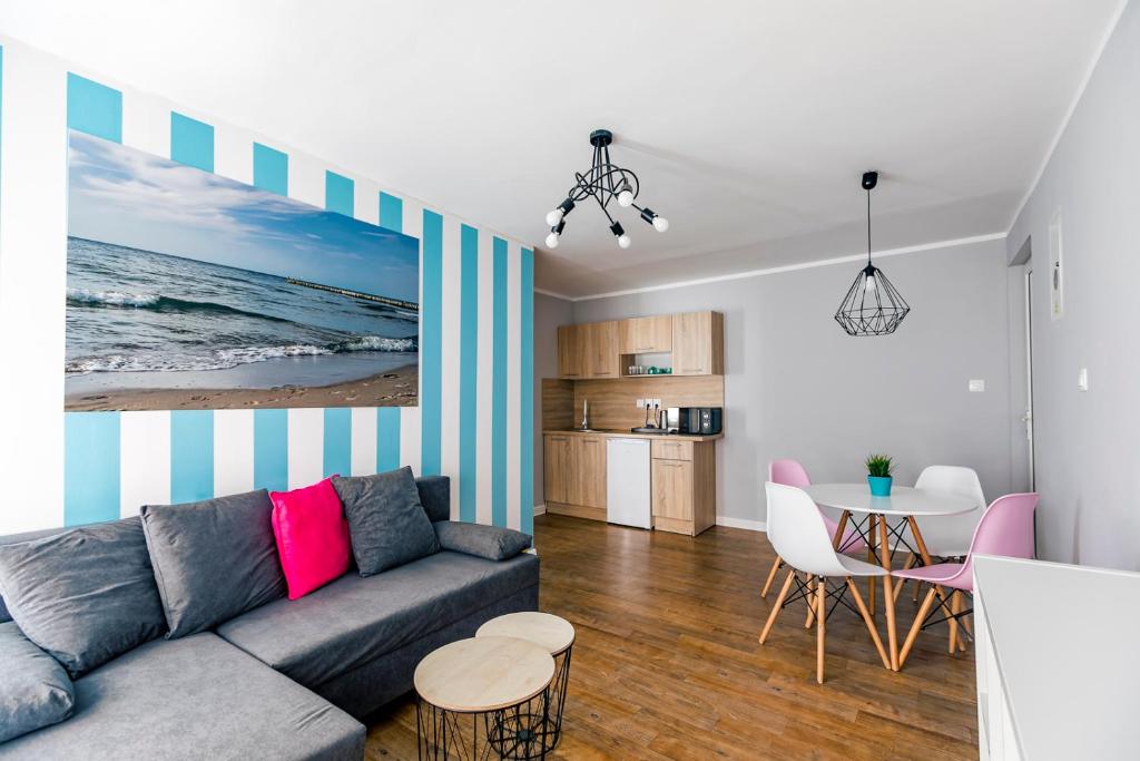 a living room with a couch and a table at Apartamenty pod Modrzewiem in Ustronie Morskie
