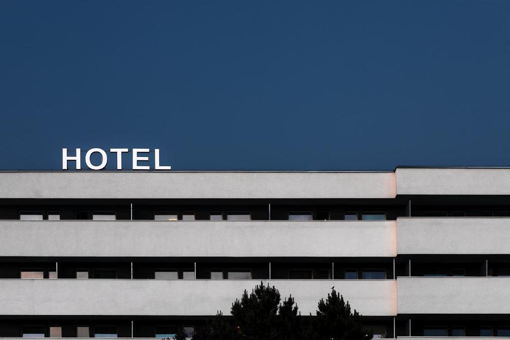 a hotel with a sign on the top of it at Hotel Slezan in Bruntál