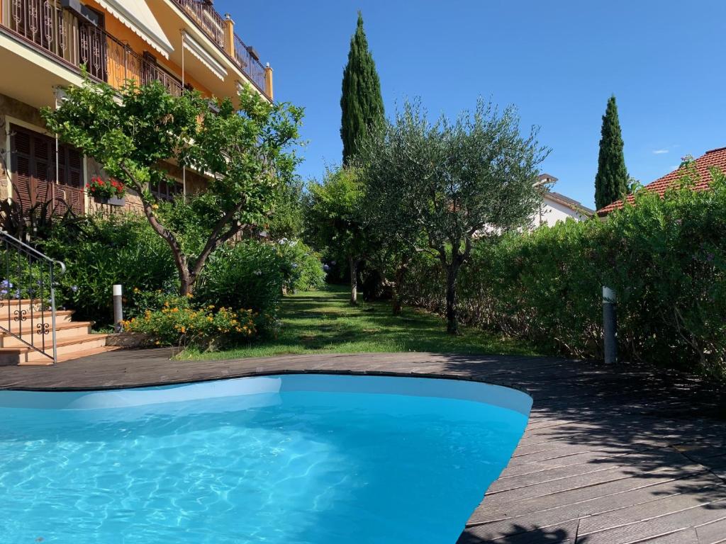 a swimming pool in front of a building at Villa Pineland in Borghetto Santo Spirito