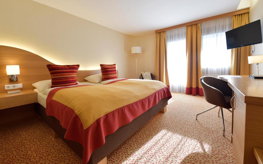 Postel nebo postele na pokoji v ubytování Seehotel Rust