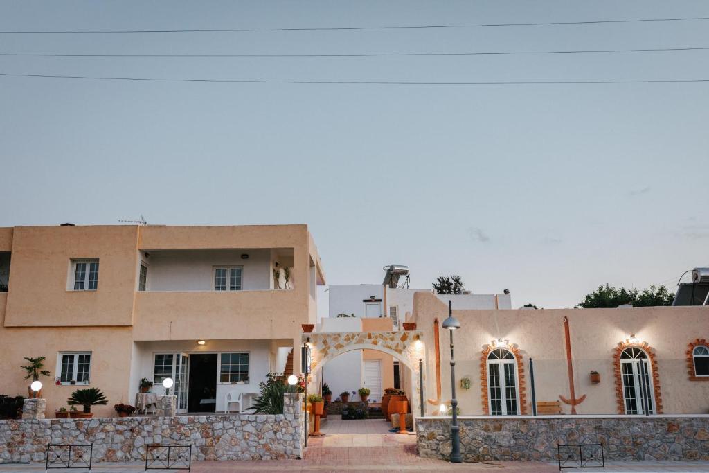 a building with an arch in front of it at Konaki Apartments in Maleme