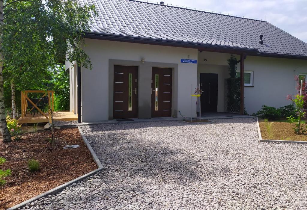 a house with two doors and a gravel driveway at Studio Beskidy in Żywiec