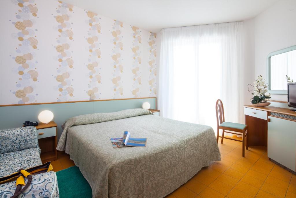 Postel nebo postele na pokoji v ubytování Hotel Universal