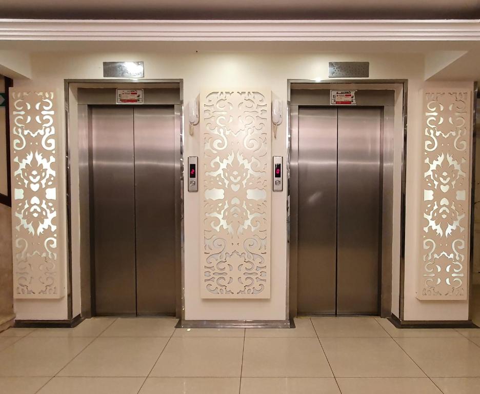 a row of elevators in a building at Saryet Al Hamra Hotel Apartments in Jeddah