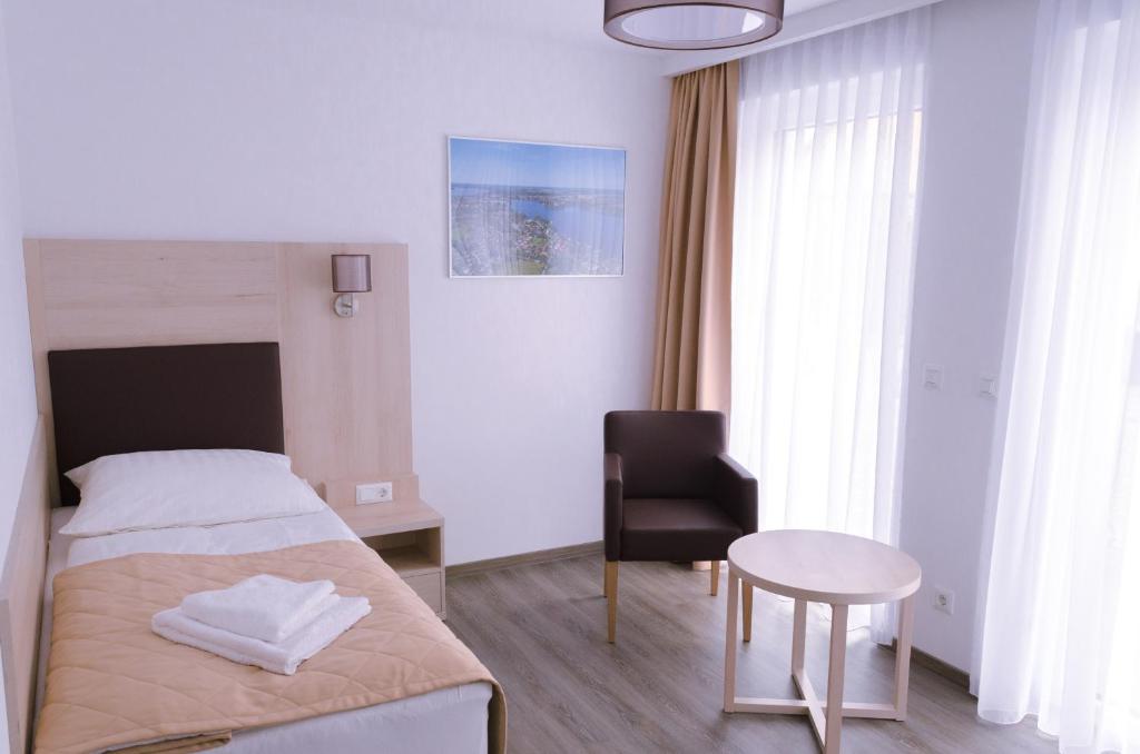 Postel nebo postele na pokoji v ubytování Glindower Alpen Pension