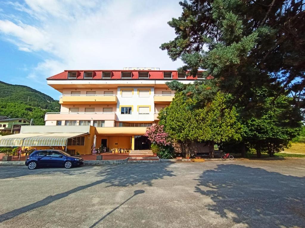 a building with a car parked in front of it at Hotel Santa Maria Del Bagno in Pesche