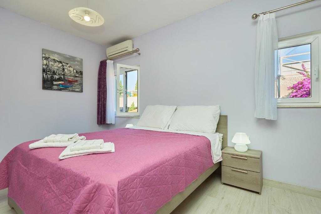 Posteľ alebo postele v izbe v ubytovaní Apartments Kolorina