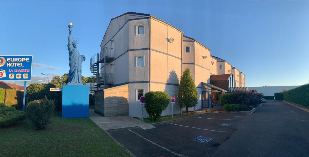 a building with a sign in front of it at Europe Hôtel in Varennes Vauzelles