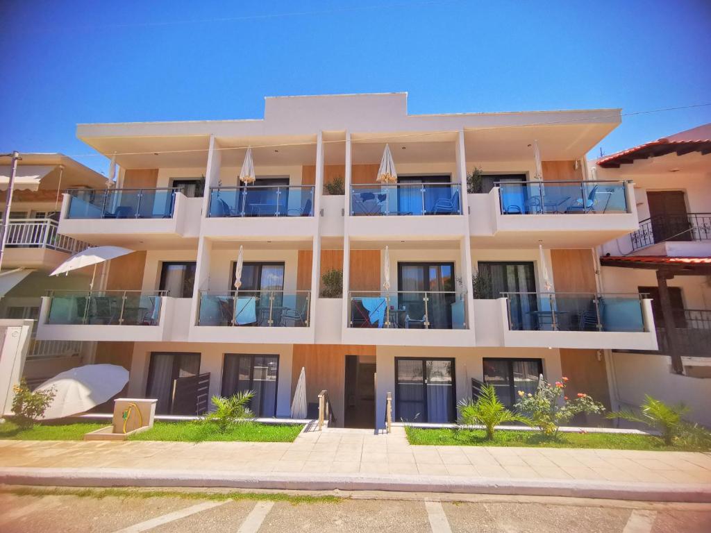 an apartment building with balconies on a street at Sarti Holidays in Sarti
