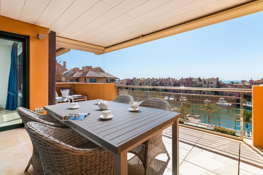 a table and chairs on a balcony with a view at Sotogrande Ribera del Marlin apartment in Sotogrande