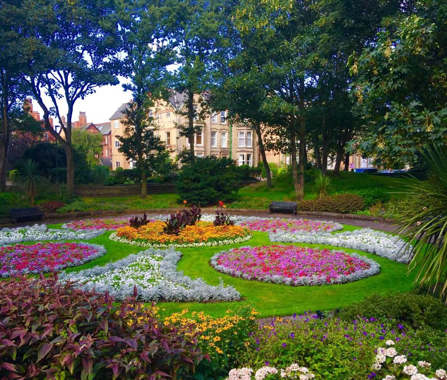 a garden of flowers in front of a building at Woodlands Holiday Apartments in Lytham St Annes