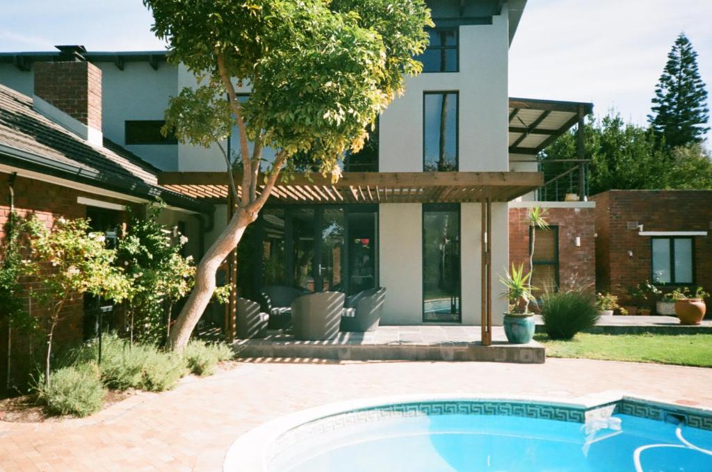 a house with a swimming pool in front of a house at 9 Windsor House in Tokai