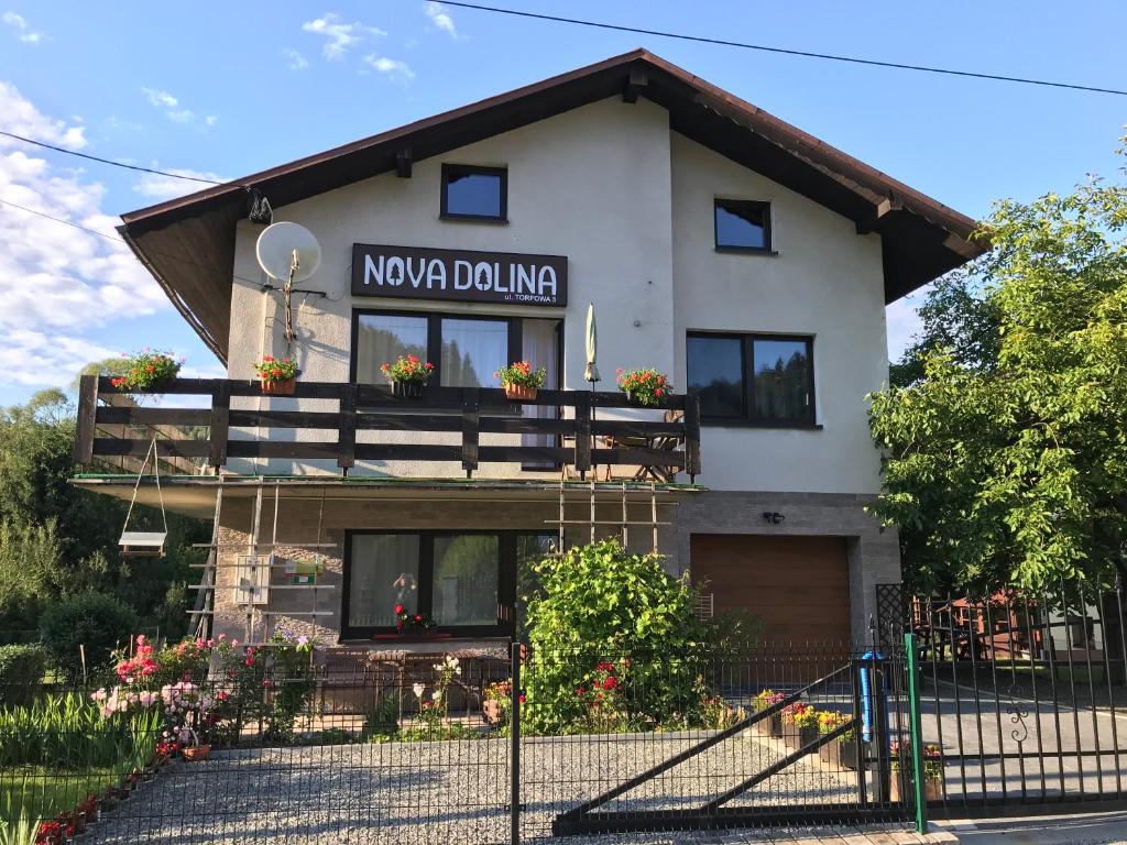 a building with a sign that reads nova polling at Apartamenty Nova Dolina in Wisła