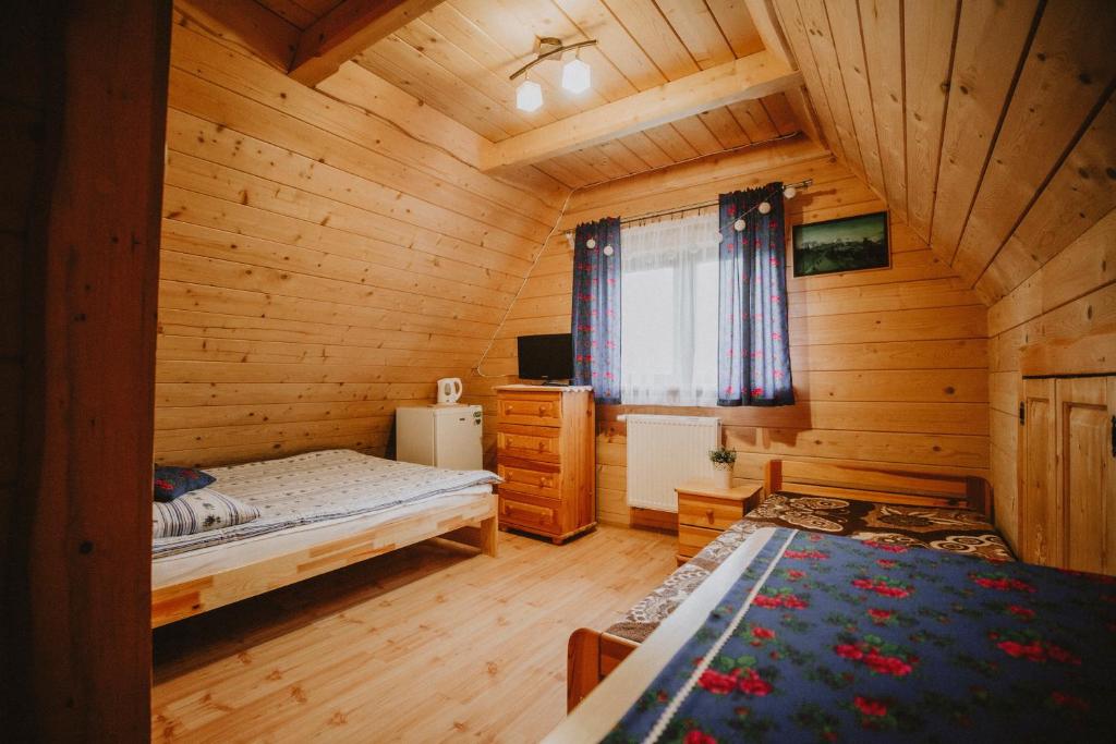 Postel nebo postele na pokoji v ubytování Domki i Pokoje obok Term Chochołów U Tadka