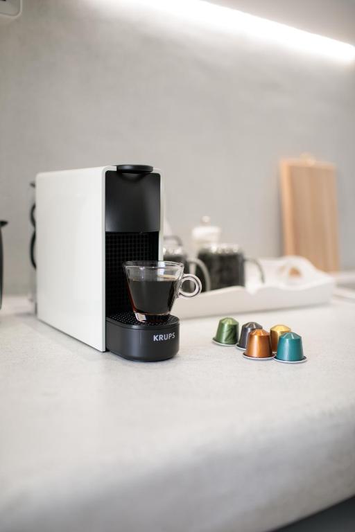 a coffee maker sitting on a counter with a cup at Hora Seaside Suites in Naxos Chora