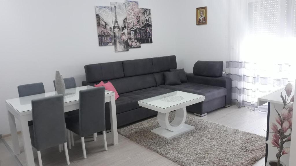 salon z kanapą i stołem w obiekcie Renome apartmani w mieście Banja Koviljača