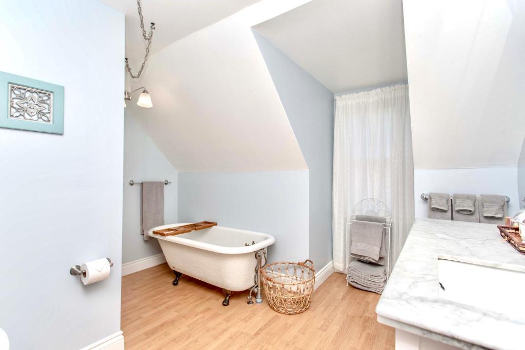 a bathroom with a bath tub and a sink at Redwood Bed and Breakfast in Niagara Falls