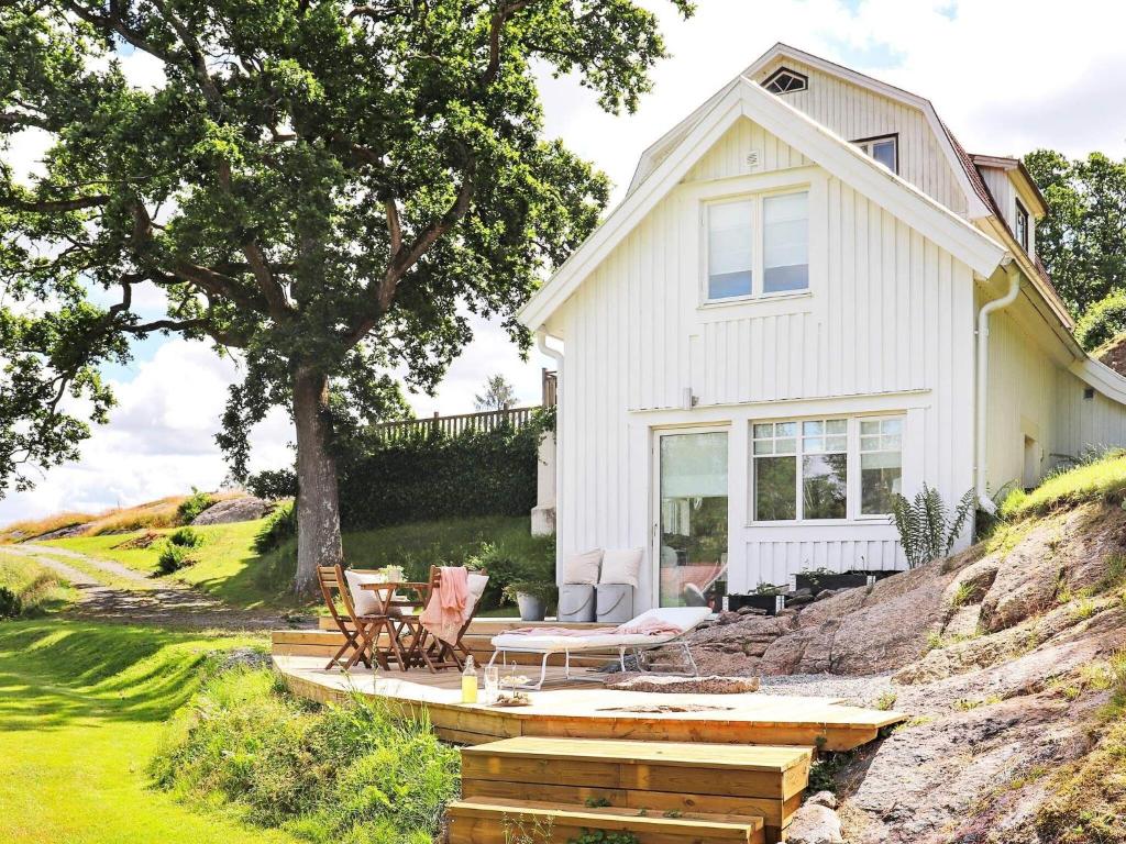 uma casa branca com um alpendre e um pátio em Holiday home Veddige II em Veddige