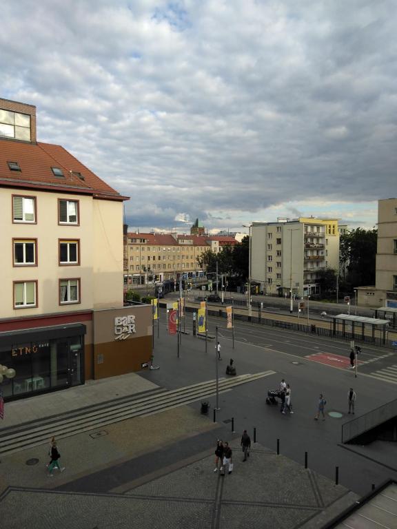 a city street with buildings and people on motorcycles at Apartament Wrocław przy Rynku in Wrocław