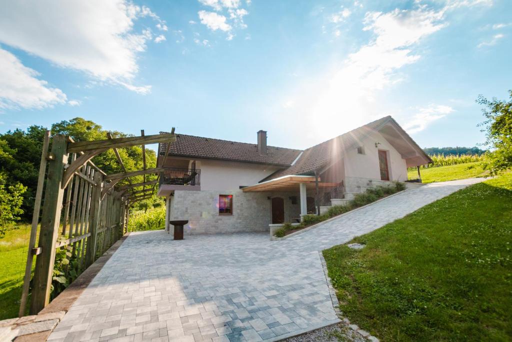 a house with a wooden gate in front of a yard at Vineyard cottage Radulja in Smarjeske Toplice