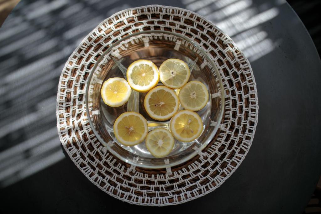 a bunch of lemon slices in a bowl on a table at Hora Seaside Suites in Naxos Chora