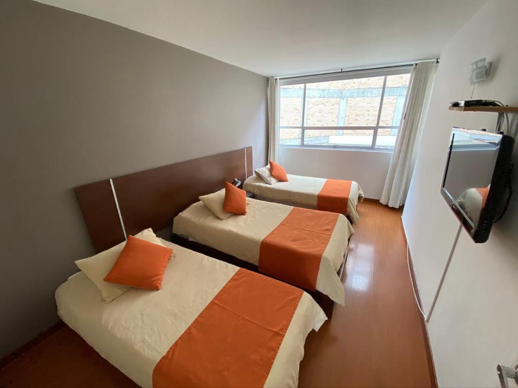 Postel nebo postele na pokoji v ubytování Hotel Juliette Bogota