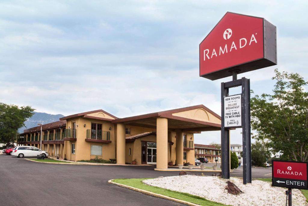 a sign in front of a hotel at Ramada by Wyndham Flagstaff East in Flagstaff