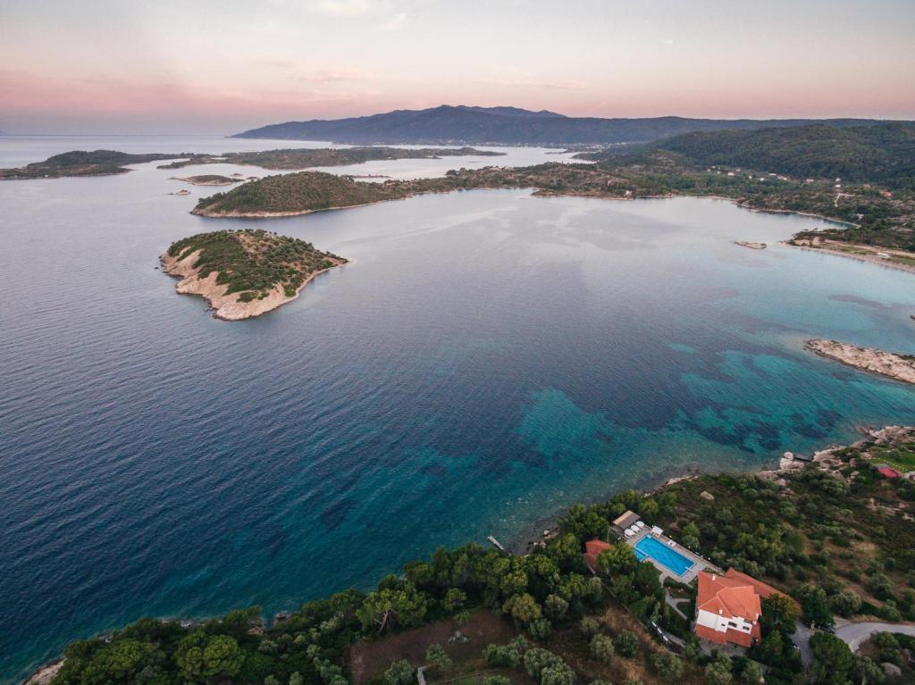 an island in the middle of a body of water at Theoxenia Apartments in Ormos Panagias