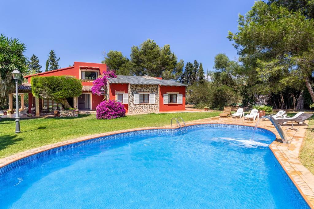 a swimming pool in front of a house at Thai Garden Villa in Palma de Mallorca