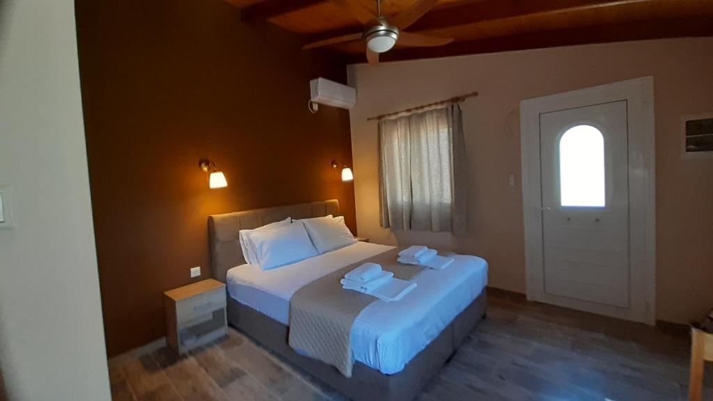 sypialnia z dużym łóżkiem i oknem w obiekcie Room near the Airport w mieście Pikérmion